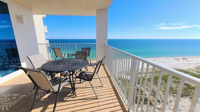 balcony featuring a water view and a view of the beach