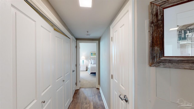 corridor with wood-type flooring