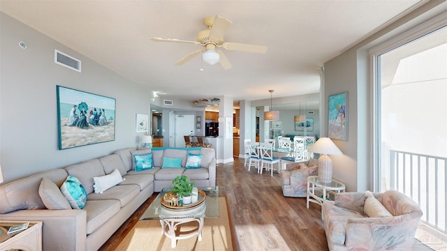 living room featuring a healthy amount of sunlight, hardwood / wood-style flooring, and ceiling fan