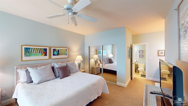 carpeted bedroom featuring a closet, ceiling fan, and connected bathroom