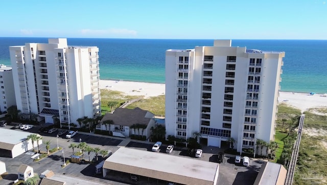 view of building exterior featuring a water view and a view of the beach