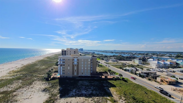 drone / aerial view featuring a water view and a beach view