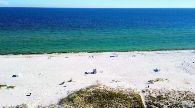 birds eye view of property featuring a water view and a view of the beach