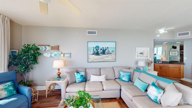 living room featuring ceiling fan and hardwood / wood-style floors