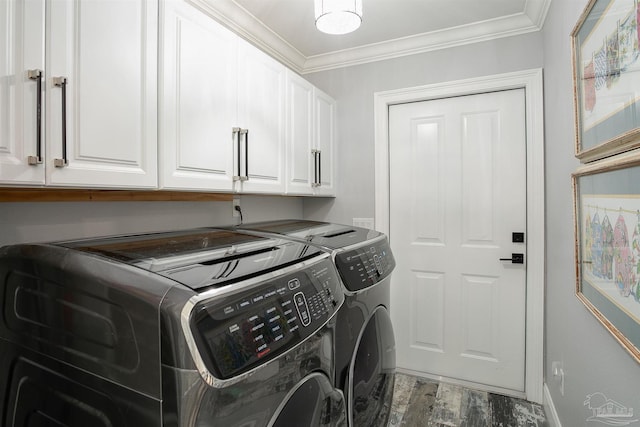 laundry area with washer and clothes dryer, cabinets, crown molding, and wood-type flooring