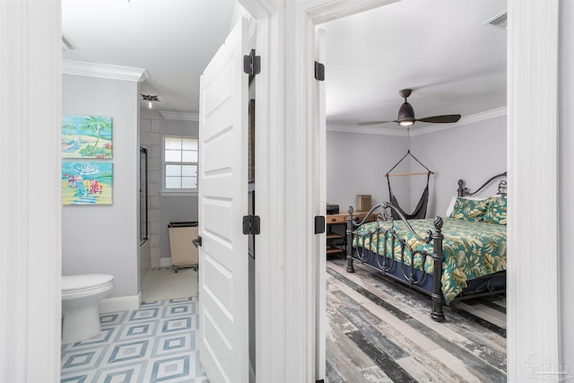 tiled bedroom featuring crown molding, ensuite bath, and ceiling fan