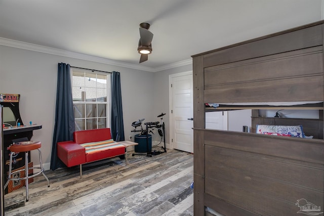 bedroom featuring crown molding, ceiling fan, and wood-type flooring