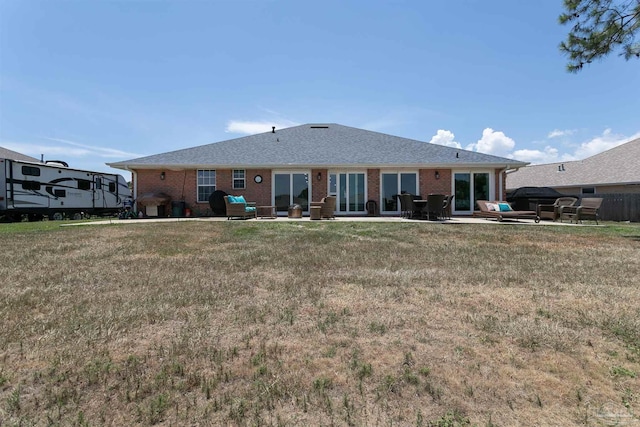 back of house featuring a patio area and a yard