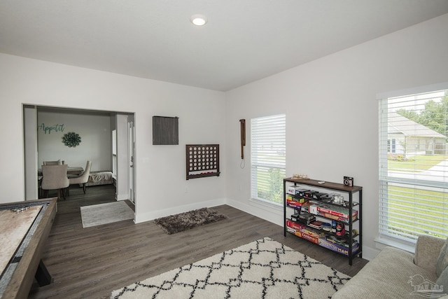 interior space featuring baseboards and dark wood finished floors