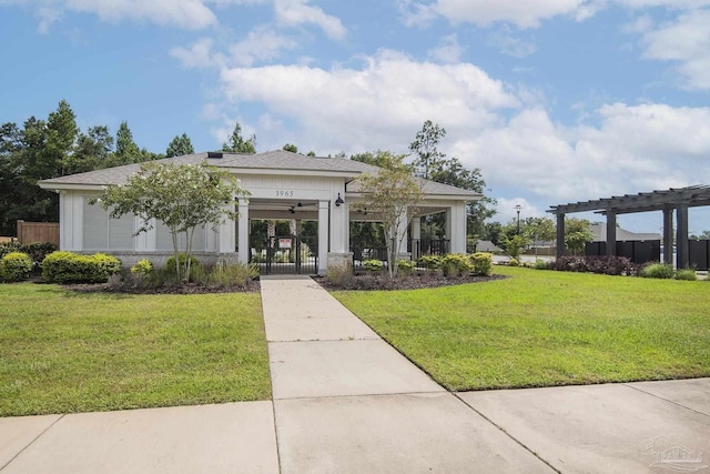 view of front facade featuring a gate, fence, a pergola, and a front yard