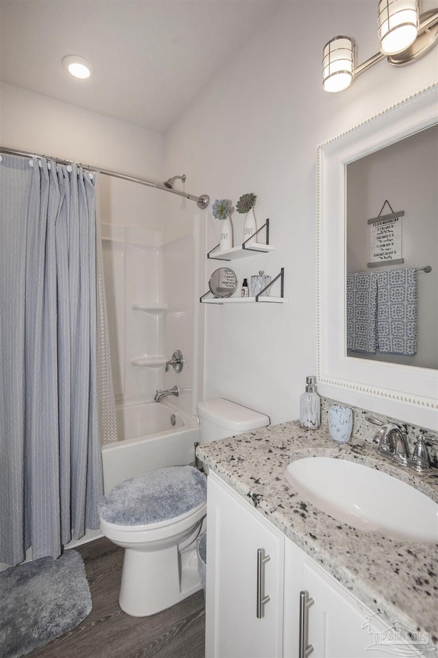 bathroom with toilet, shower / bath combo, wood finished floors, and vanity