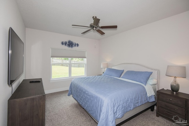 bedroom featuring ceiling fan, baseboards, and light colored carpet