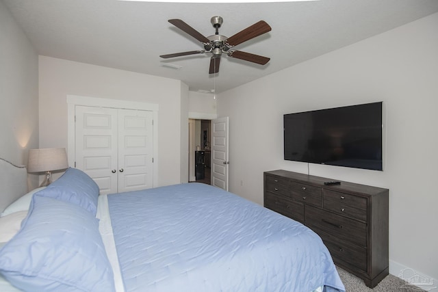 bedroom with baseboards, visible vents, a ceiling fan, light colored carpet, and a closet