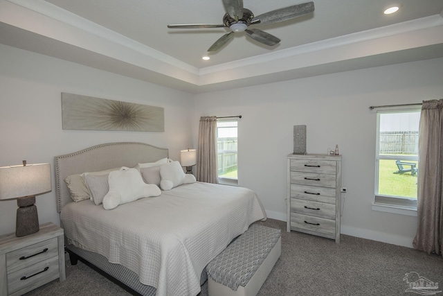 carpeted bedroom featuring baseboards, ornamental molding, a tray ceiling, and recessed lighting