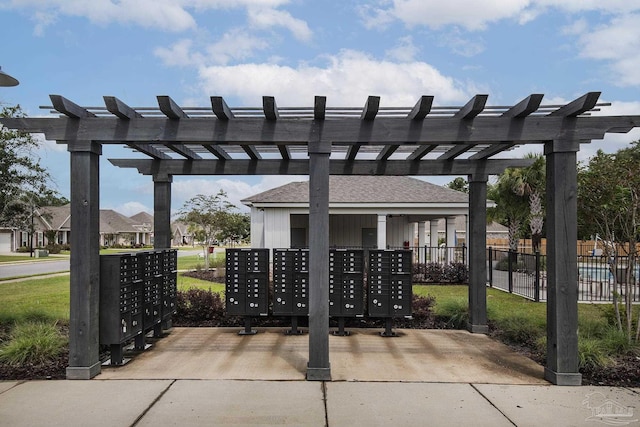 view of community with fence and mail area