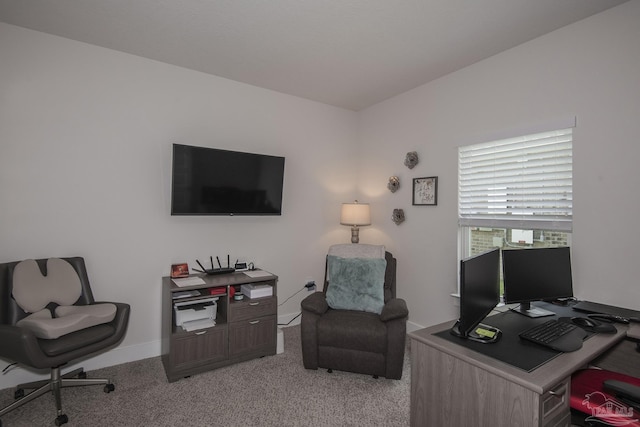 office area featuring light carpet and baseboards