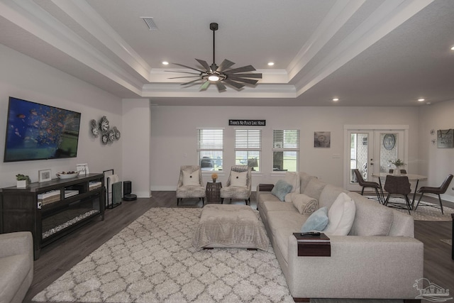 living area featuring a tray ceiling, french doors, dark wood finished floors, recessed lighting, and baseboards