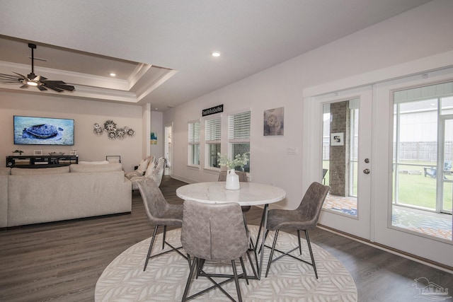 dining area featuring ornamental molding, a tray ceiling, french doors, and wood finished floors