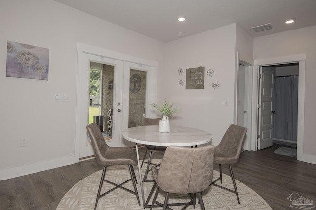 dining room featuring dark wood-style floors, french doors, recessed lighting, visible vents, and baseboards