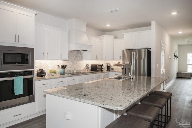 kitchen featuring a center island with sink, appliances with stainless steel finishes, and a sink