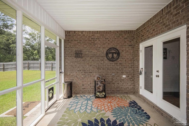 sunroom / solarium featuring french doors