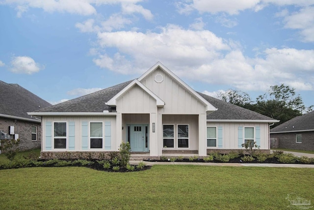 view of front of property with a shingled roof, a front lawn, and board and batten siding