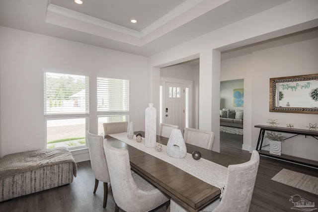 dining area featuring ornamental molding, recessed lighting, a raised ceiling, and dark wood-style flooring