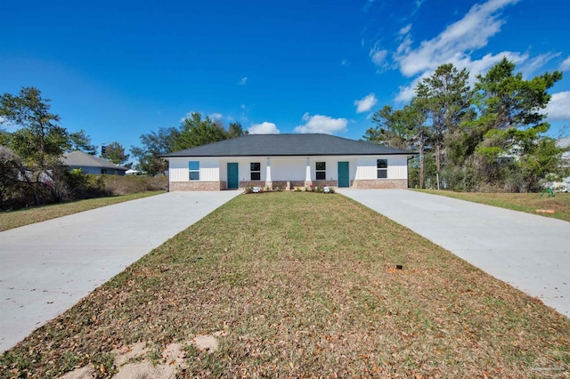 ranch-style house featuring concrete driveway and a front lawn