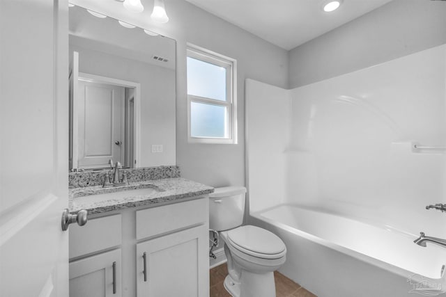 bathroom with toilet, vanity, visible vents, tub / shower combination, and tile patterned floors