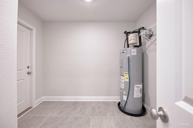 utility room featuring electric water heater