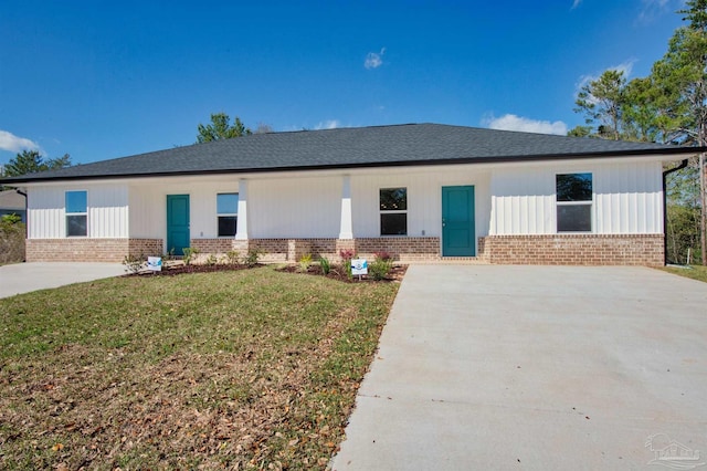 single story home with a front lawn and brick siding