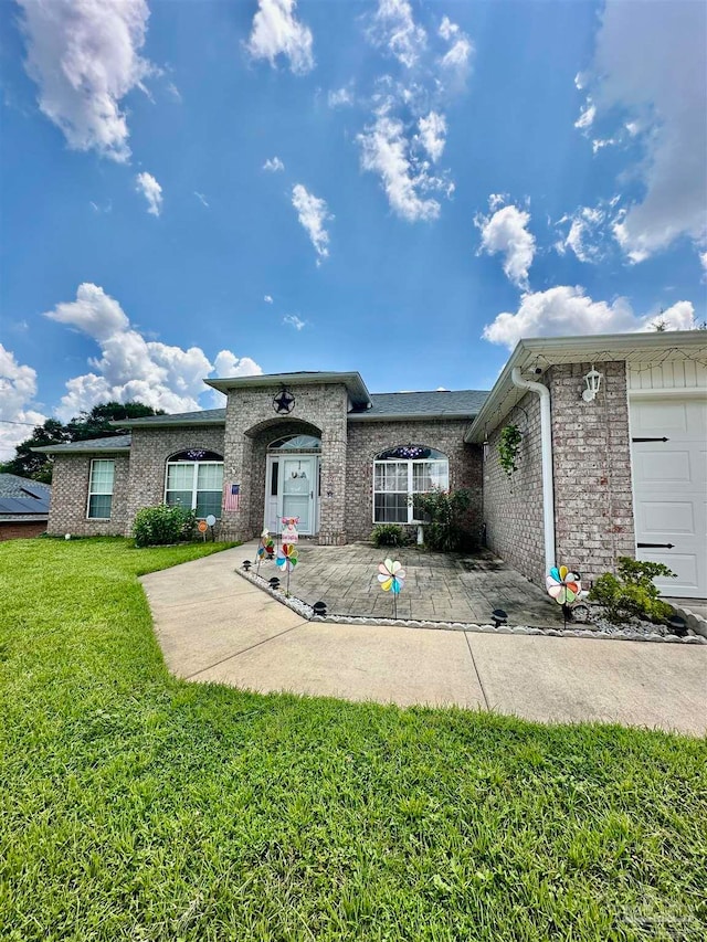 view of front of house with a garage and a front yard