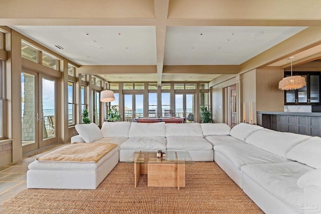 living room with french doors and beamed ceiling