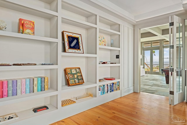 interior space featuring french doors, wood-type flooring, and built in features