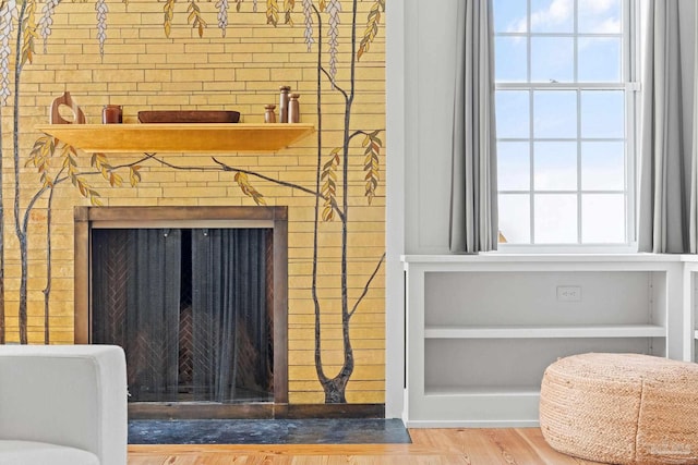 interior details with hardwood / wood-style flooring and a large fireplace