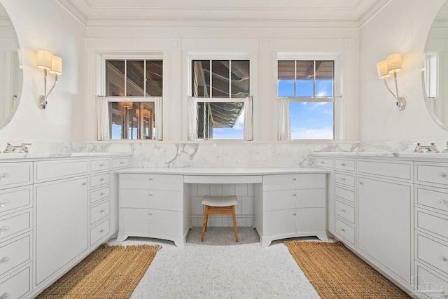 bathroom featuring crown molding and vanity