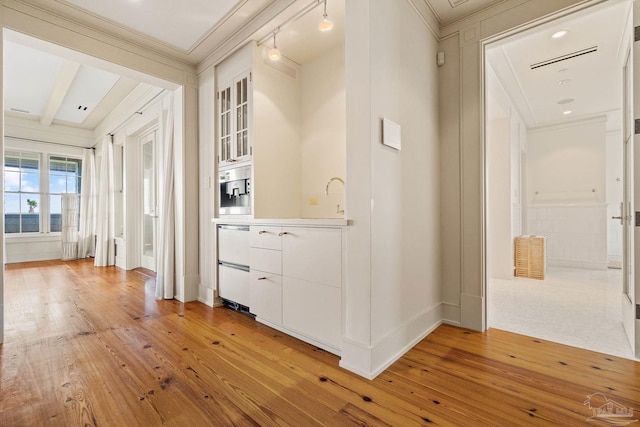 bar featuring white cabinetry, wood-type flooring, and crown molding