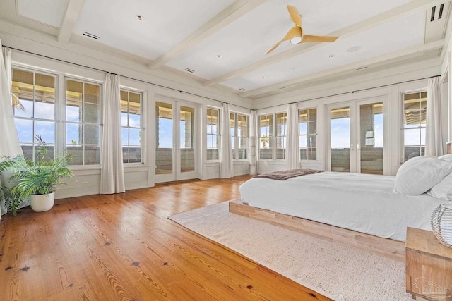 bedroom with access to outside, hardwood / wood-style floors, beam ceiling, and french doors