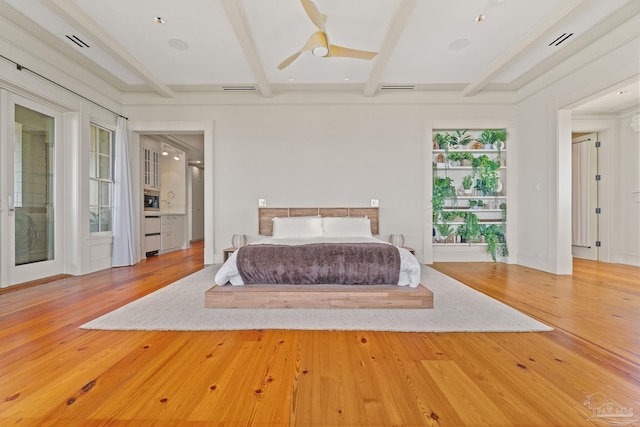 unfurnished bedroom featuring hardwood / wood-style flooring and beamed ceiling