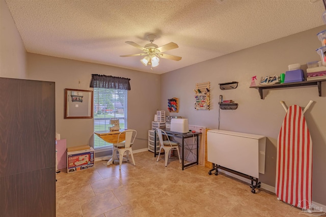 interior space featuring ceiling fan and a textured ceiling