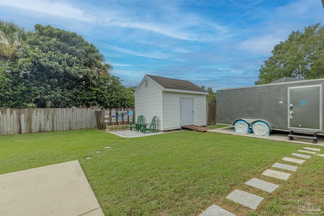 view of yard with a shed and a patio