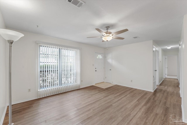 spare room with light hardwood / wood-style flooring and ceiling fan