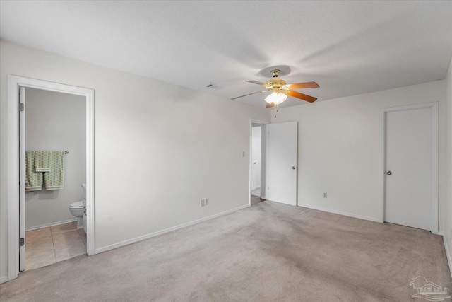 empty room with light colored carpet and ceiling fan