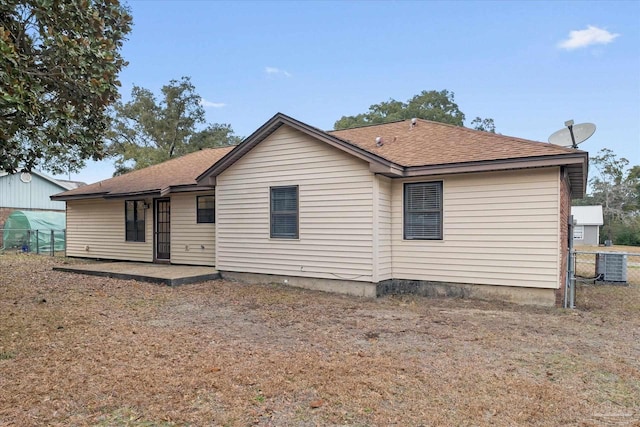 rear view of property featuring cooling unit