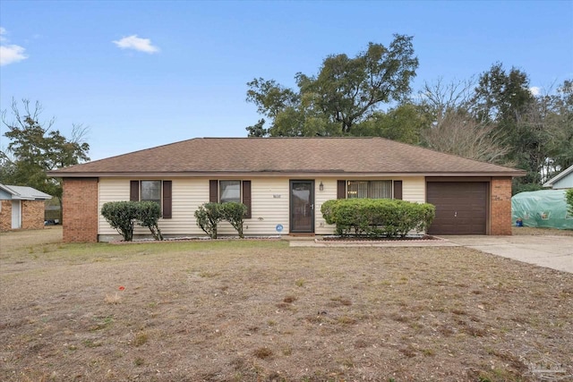 ranch-style house featuring a garage and a front lawn