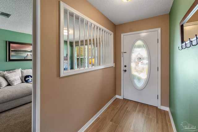 917 Broken Arrow Ln, Pensacola, FL 32533 - foyer entrance featuring a textured ceiling, baseboards, and wood finished floors