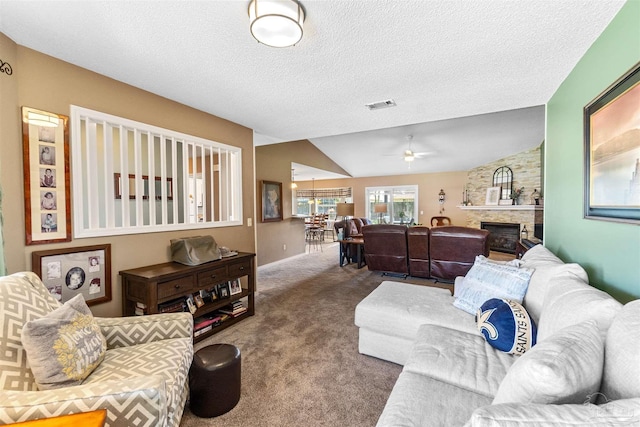 917 Broken Arrow Ln, Pensacola, FL 32533 - living area with carpet, ceiling fan, a fireplace, a textured ceiling, and vaulted ceiling