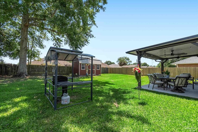 917 Broken Arrow Ln, Pensacola, FL 32533 - view of yard featuring ceiling fan, a storage unit, an outbuilding, and a patio