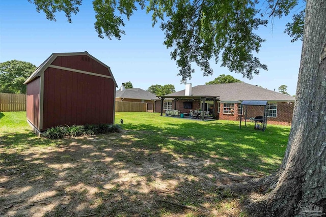 917 Broken Arrow Ln, Pensacola, FL 32533 - view of yard featuring a shed, an outbuilding, and a patio