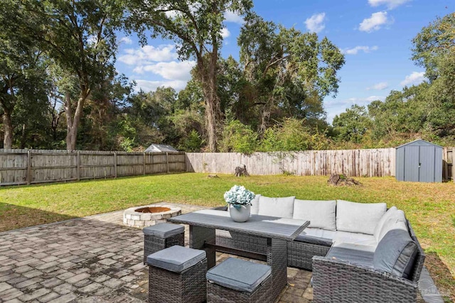 view of patio featuring an outdoor living space with a fire pit and a shed